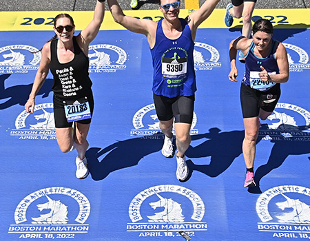 David Nusz, MD, crosses the finish line at the 2022 Boston Marathon.
